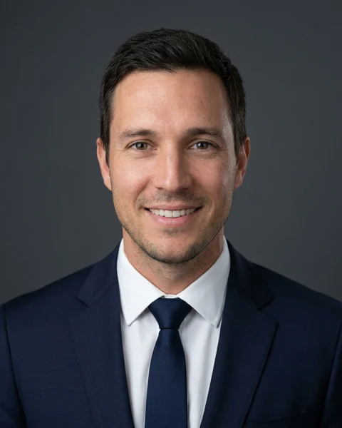 Professional headshot made with AI from the selfie: Charcoal · suit & tie, men’s cut